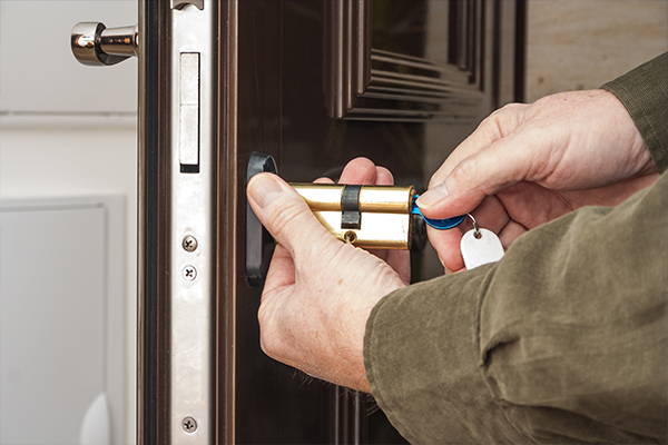 An image of a locksmith installing a new lock on a door